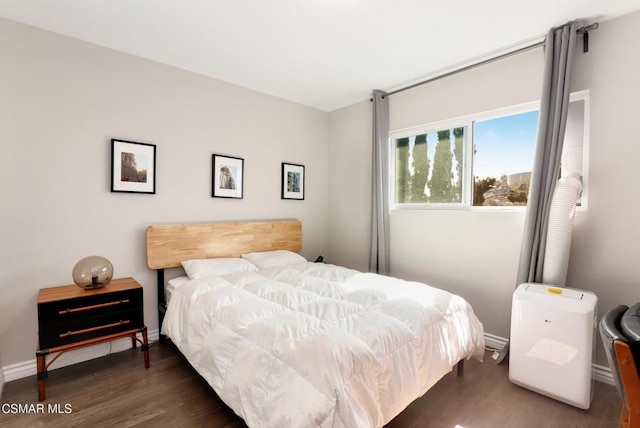 bedroom with dark hardwood / wood-style floors