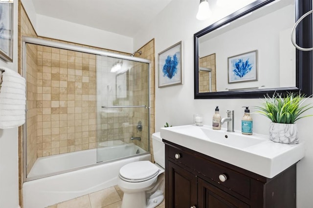 full bathroom featuring tile patterned flooring, vanity, toilet, and shower / bath combination with glass door