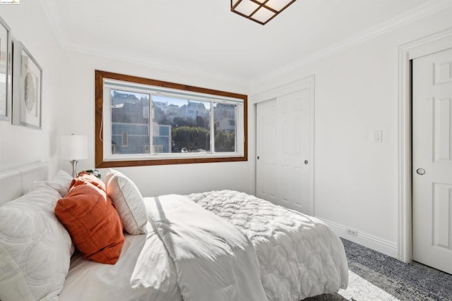 carpeted bedroom featuring crown molding and a closet