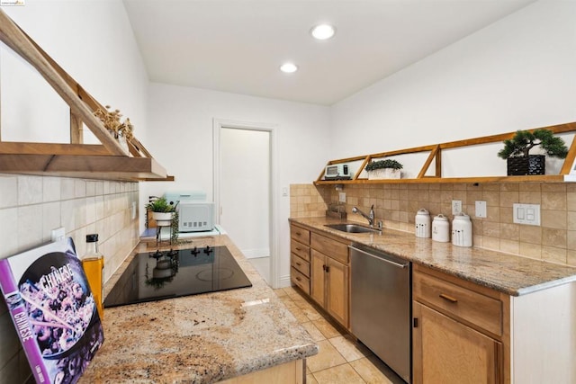 kitchen featuring black electric cooktop, light stone counters, sink, and stainless steel dishwasher