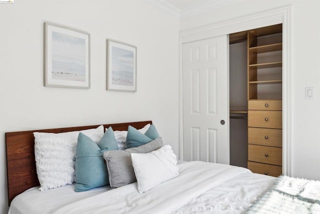 bedroom featuring a closet and crown molding