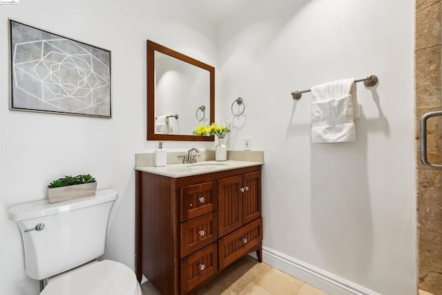 bathroom with tile patterned floors, vanity, and toilet