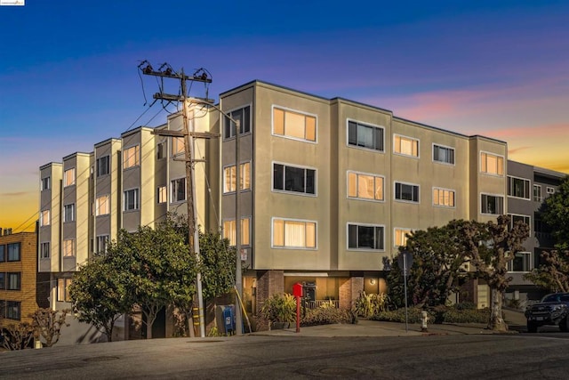 view of outdoor building at dusk