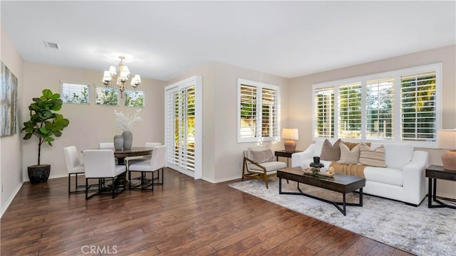 living room featuring dark hardwood / wood-style floors and an inviting chandelier