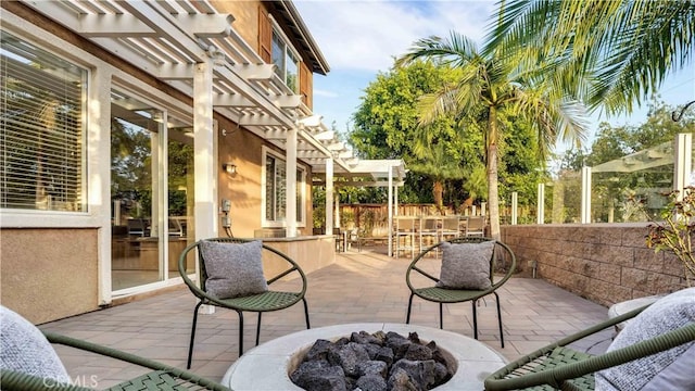 view of patio / terrace featuring a pergola and an outdoor fire pit