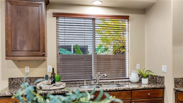 kitchen with dark stone countertops and sink