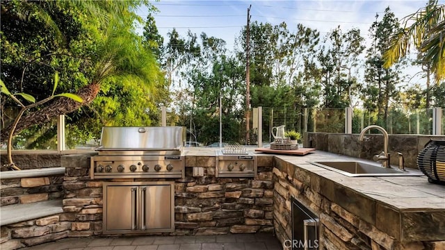 view of patio with area for grilling and sink