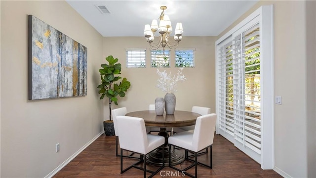 dining room with a chandelier and dark hardwood / wood-style floors