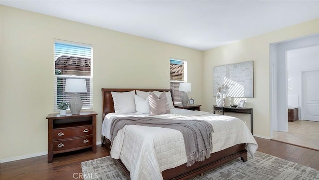 bedroom with dark hardwood / wood-style flooring