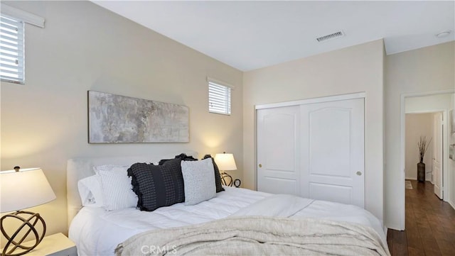 bedroom featuring dark hardwood / wood-style floors and a closet