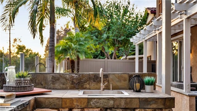 view of patio / terrace with a pergola and sink