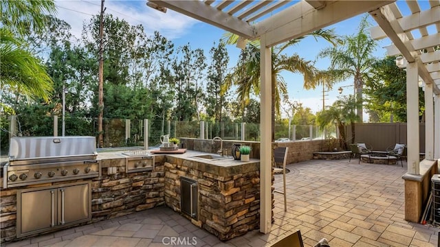 view of patio / terrace featuring a pergola, area for grilling, sink, a fire pit, and a grill