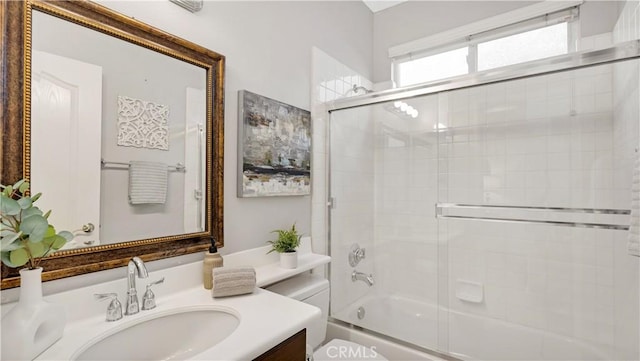 full bathroom with vanity, toilet, and combined bath / shower with glass door