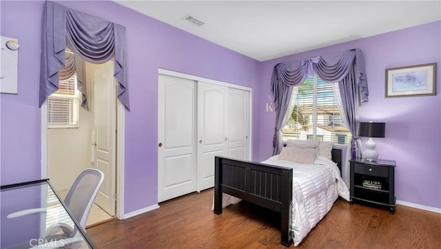 bedroom featuring a closet and dark hardwood / wood-style floors