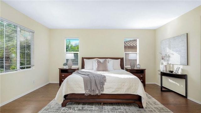 bedroom with dark wood-type flooring