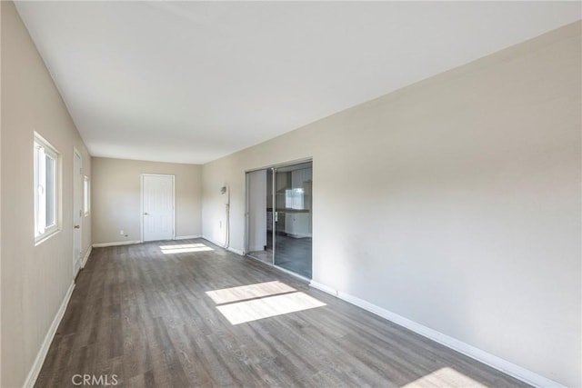 spare room with dark wood-type flooring