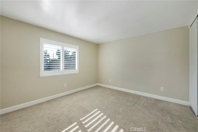 spare room with light colored carpet