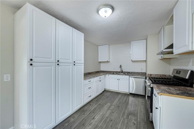 kitchen featuring sink, appliances with stainless steel finishes, white cabinets, exhaust hood, and light wood-type flooring