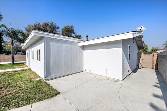 view of property exterior with a patio area