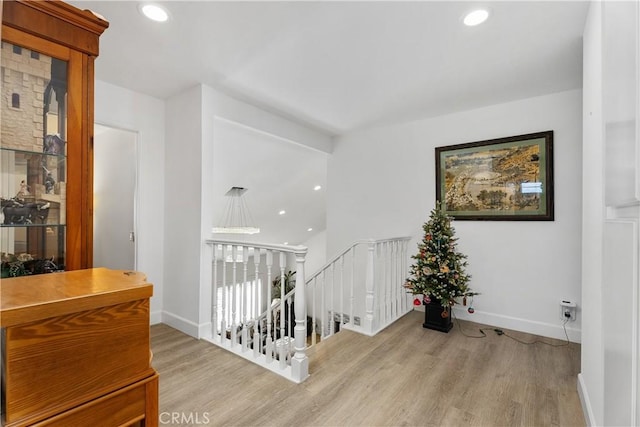 corridor with light hardwood / wood-style flooring