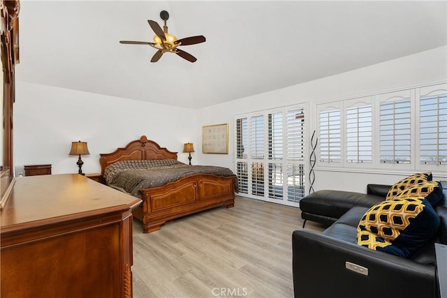 bedroom featuring access to exterior, ceiling fan, and light wood-type flooring