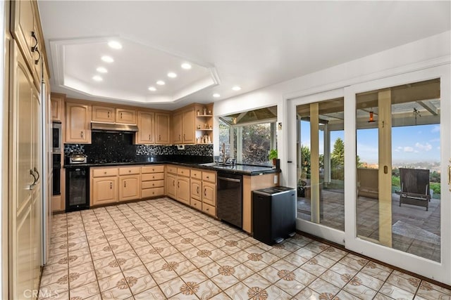 kitchen with light brown cabinetry, dishwasher, wine cooler, decorative backsplash, and a tray ceiling