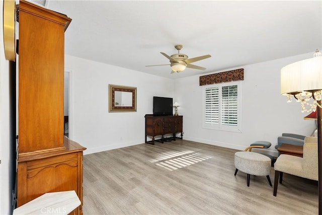 sitting room with light hardwood / wood-style floors and ceiling fan