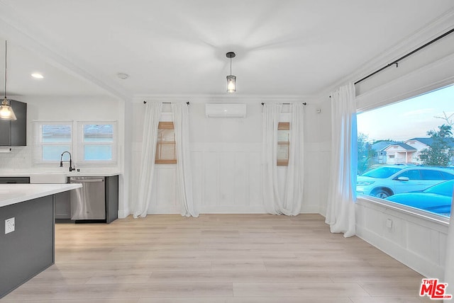 interior space with stainless steel dishwasher, pendant lighting, an AC wall unit, and backsplash