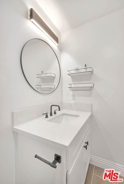 bathroom featuring tile patterned flooring and vanity