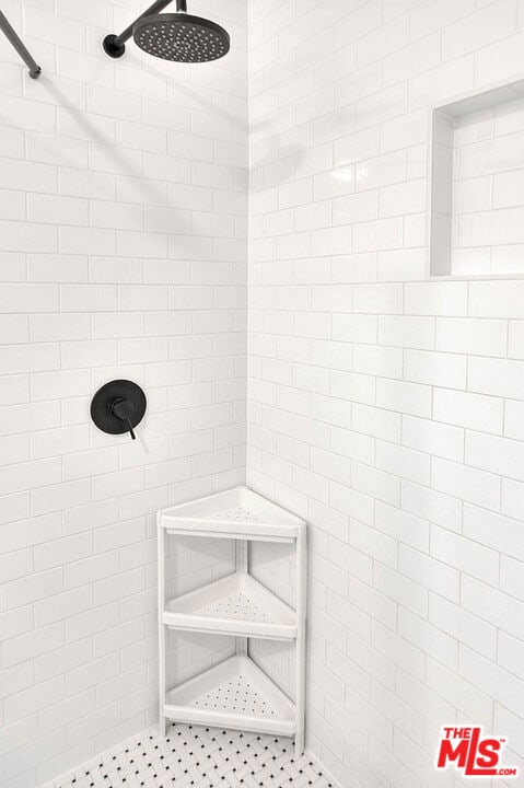 bathroom with a tile shower