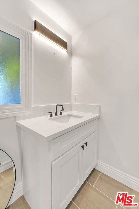 bathroom with tile patterned flooring and vanity