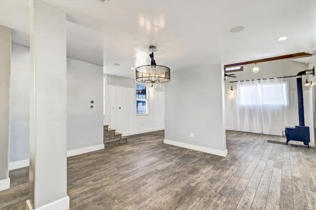 interior space featuring hardwood / wood-style flooring and ceiling fan with notable chandelier