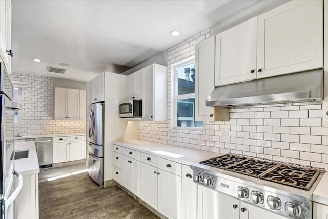 kitchen featuring white cabinetry, appliances with stainless steel finishes, and tasteful backsplash