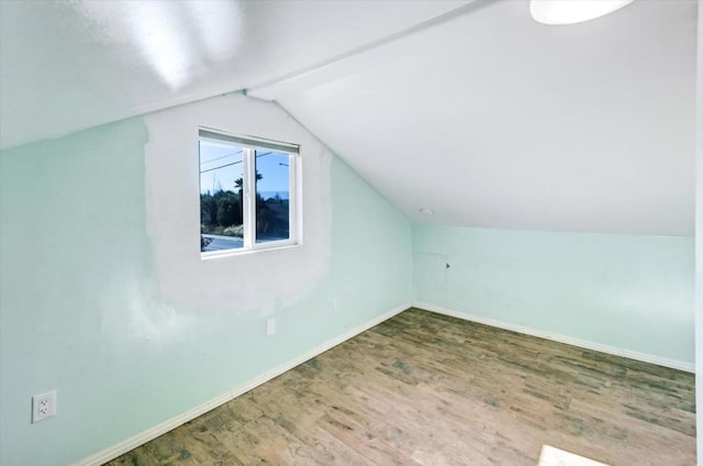 additional living space featuring wood-type flooring and lofted ceiling