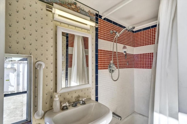 bathroom featuring sink and shower / bath combination with curtain