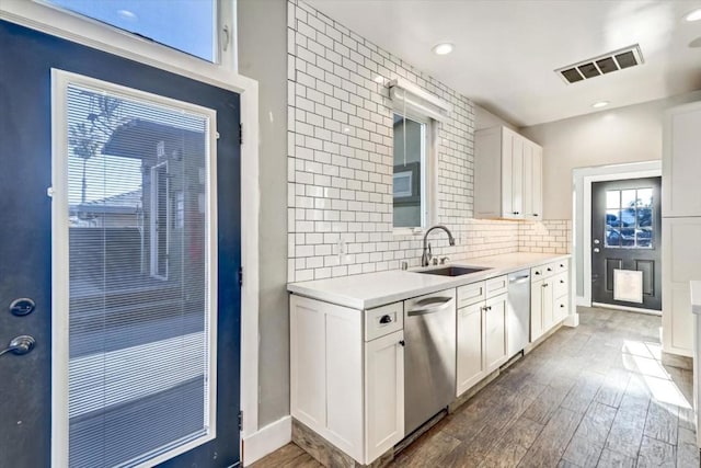 kitchen featuring dishwasher, dark hardwood / wood-style floors, white cabinetry, and sink