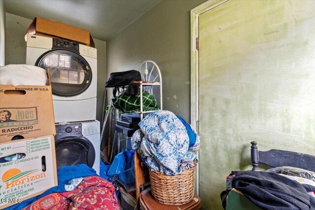 laundry area featuring stacked washer / dryer