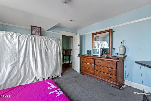 bedroom featuring dark colored carpet