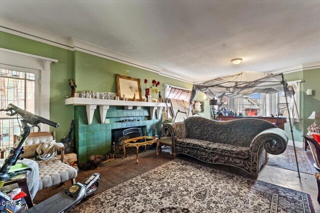 living room featuring a tile fireplace and concrete flooring