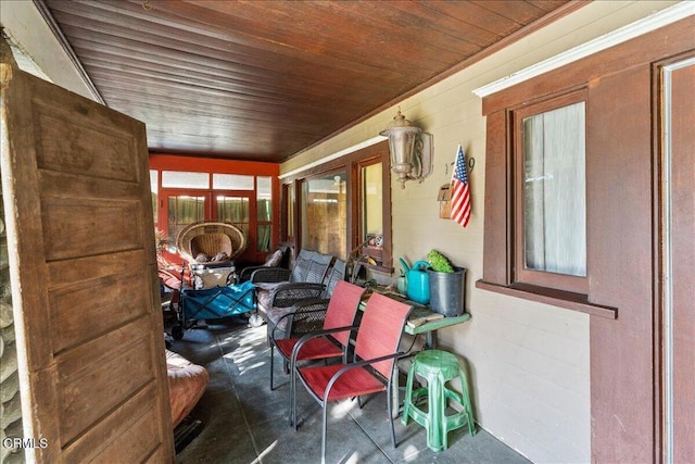 sunroom / solarium featuring wood ceiling