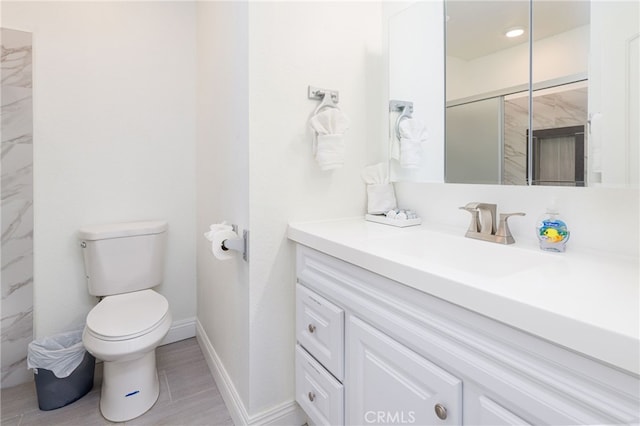 bathroom with vanity, toilet, and walk in shower