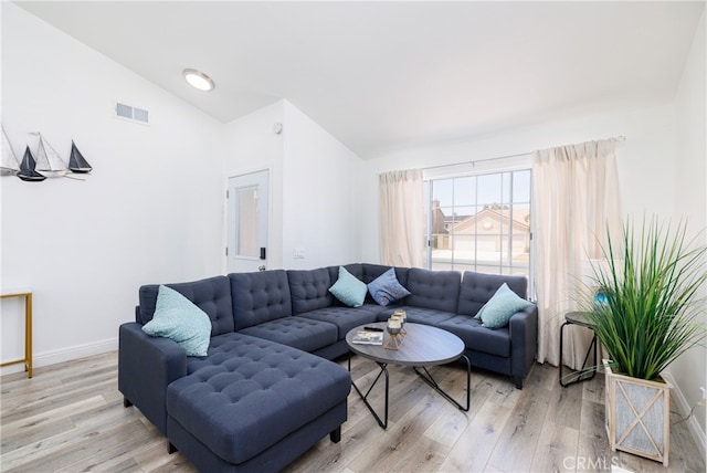 living room with lofted ceiling and light wood-type flooring