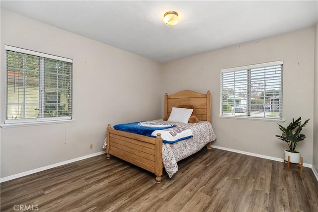 bedroom with dark hardwood / wood-style flooring