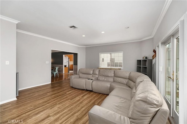 living room featuring hardwood / wood-style flooring and ornamental molding