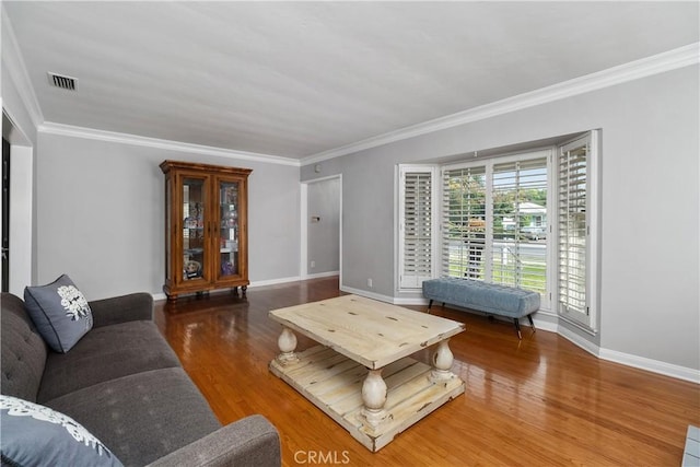 living room featuring dark hardwood / wood-style flooring and ornamental molding