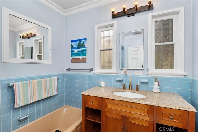 bathroom featuring vanity, crown molding, tile walls, and a tub