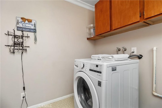 laundry room featuring washer / clothes dryer, crown molding, and cabinets