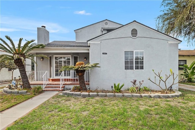 view of front of home featuring a front yard and a porch