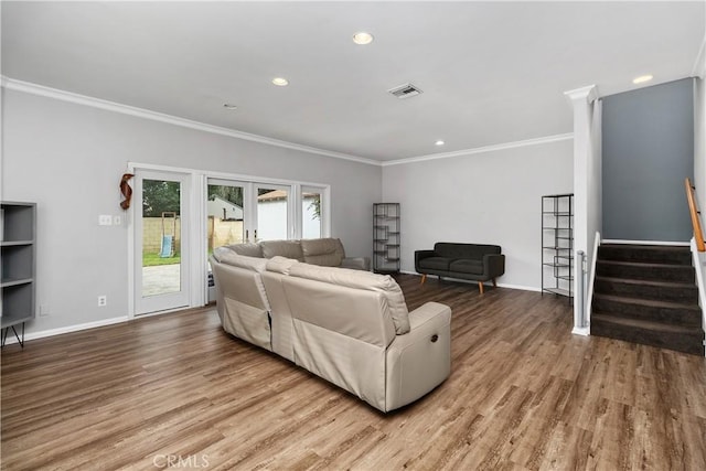 living room featuring french doors, wood-type flooring, and ornamental molding