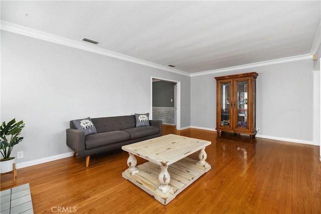 living room featuring wood-type flooring and ornamental molding